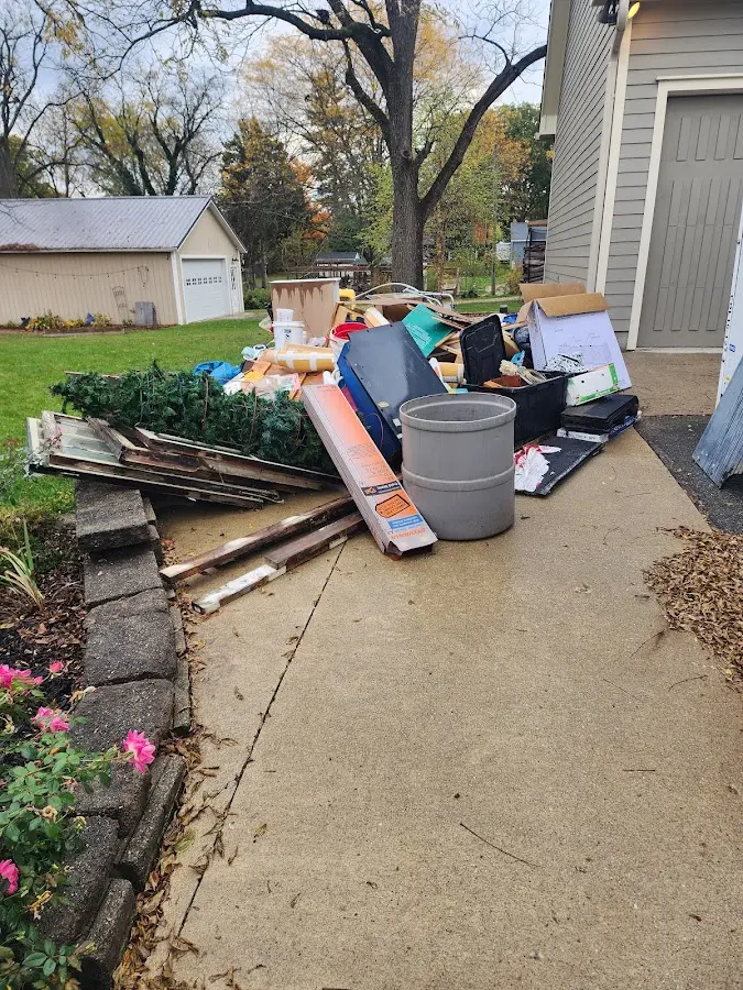 Dumpster being loaded with debris for Residential Dumpster Rental in Tuscola